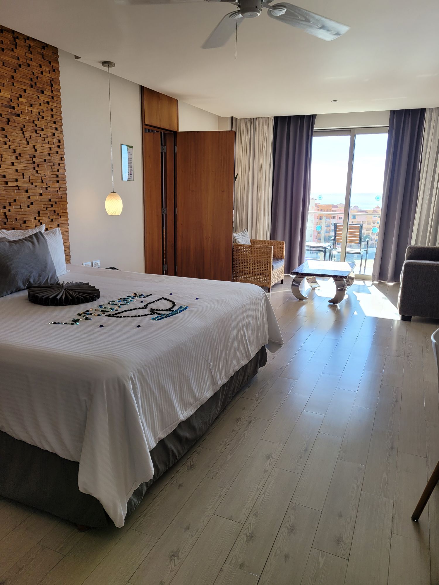 Bright guest room at Sandos Finisterra with a balcony and ocean view